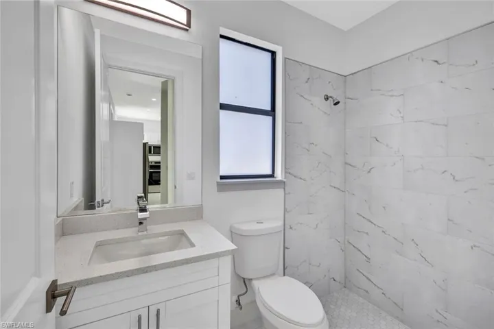 Full bath featuring vanity and a stall shower