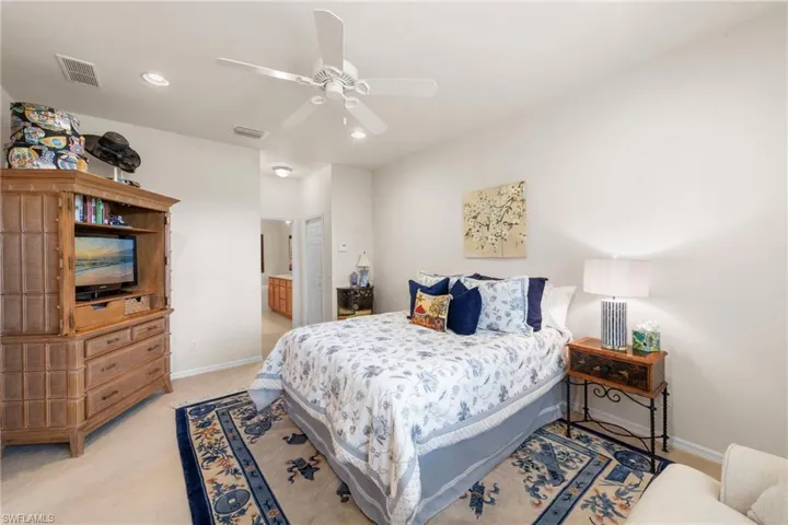 Bedroom featuring a ceiling fan, light colored carpet, ensuite bathroom, and recessed lighting