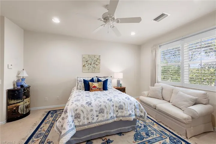Bedroom featuring light carpet, ceiling fan, and recessed lighting