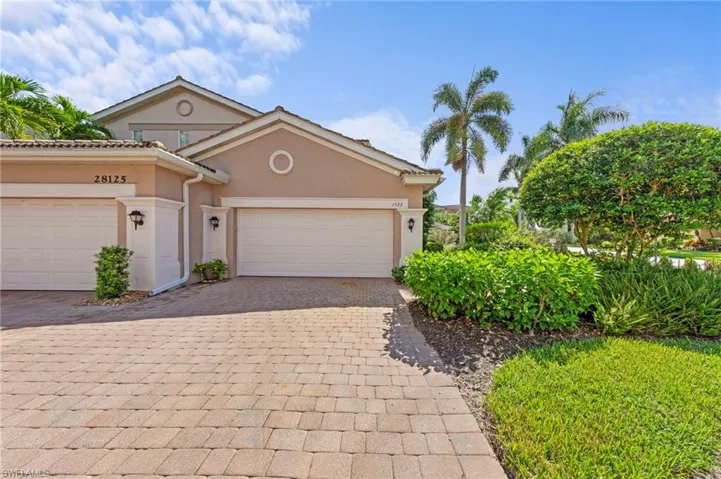 Mediterranean / spanish-style home featuring stucco siding, decorative driveway, and a garage