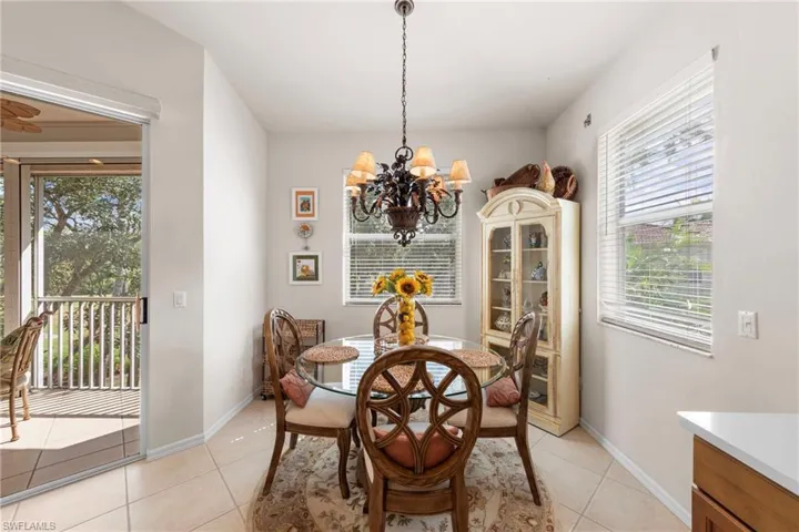 Dining area with light tile patterned flooring and a chandelier