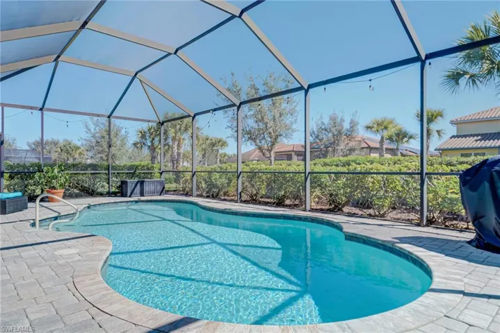 Outdoor pool featuring a lanai, and grilling area