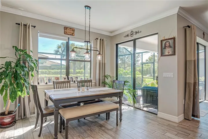 Dining room with plank tile floors and crown molding