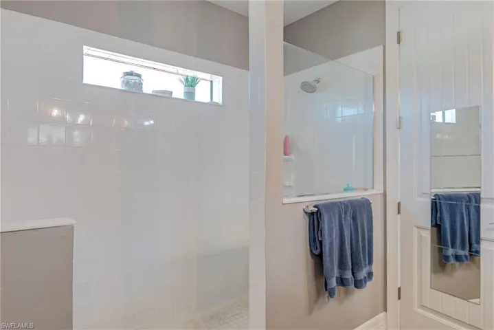 Bathroom with a walk in shower and plenty of natural light