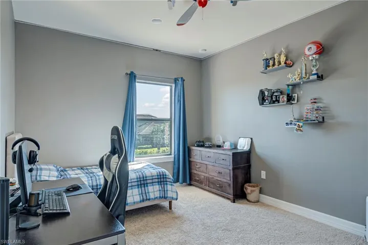 Bedroom featuring carpet and ceiling fan