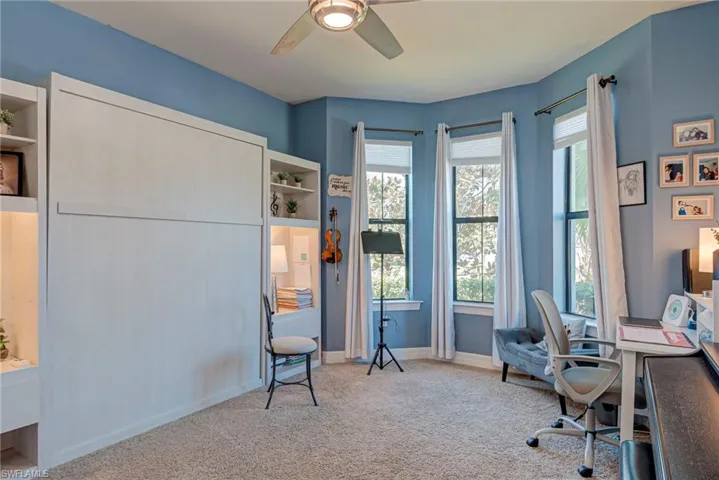 Carpeted bedroom with ceiling fan