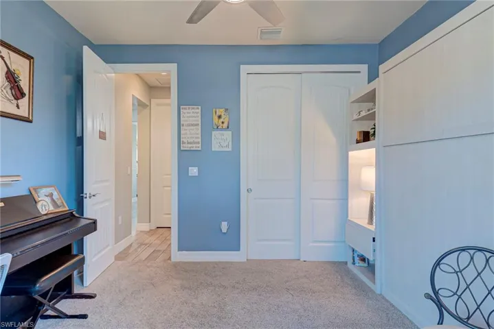 Bedroom with carpeting and ceiling fan