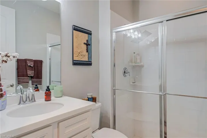 Full bathroom with vanity and a stall shower