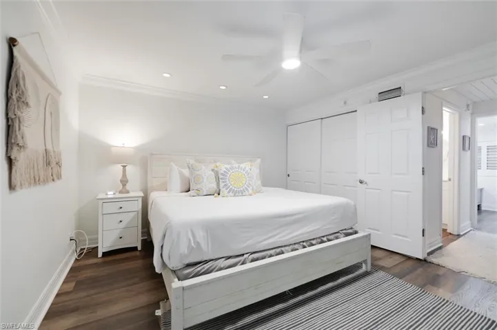 Bedroom with ornamental molding, ceiling fan, a closet, dark wood-type flooring, and recessed lighting