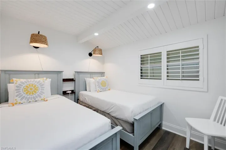 Bedroom with dark wood finished floors and wooden ceiling