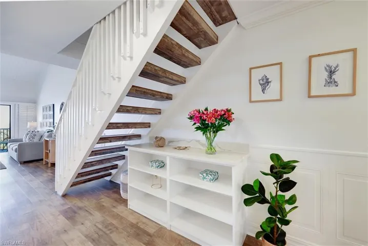 Stairs featuring wood finished floors