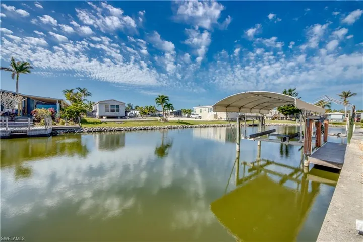 Dock featuring boat lift and a water view