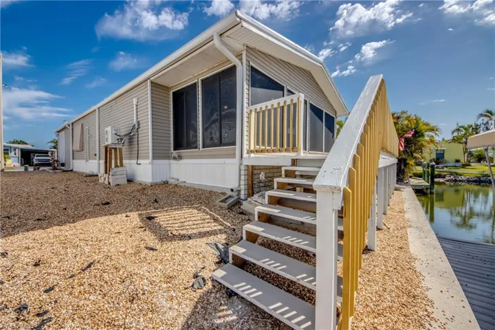 Back of house featuring a sunroom and stairs