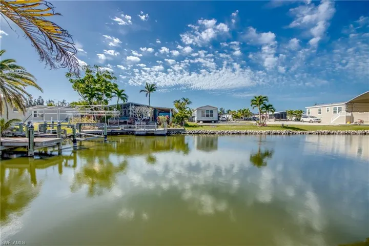 Water view with boat lift and a dock