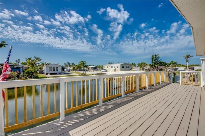 Deck featuring a water view and a residential view