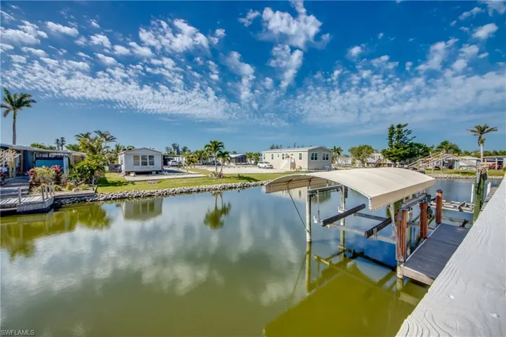 Dock area featuring boat lift and a water view