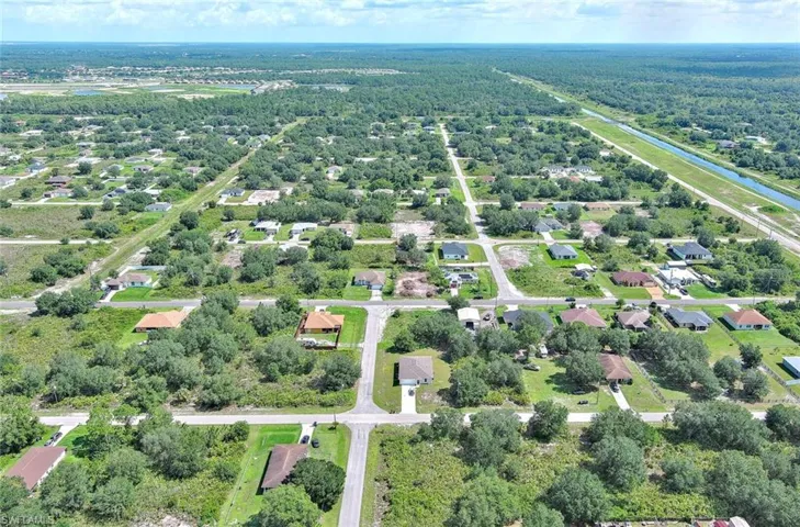 Aerial perspective of suburban area featuring a nearby body of water