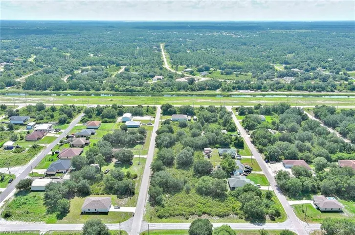 Aerial view of residential area featuring a nearby body of water