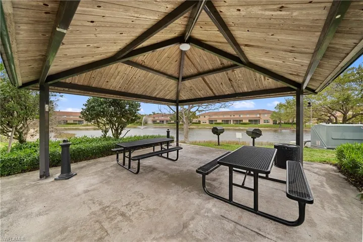 View of patio / terrace featuring a residential view, a grill, and a water view