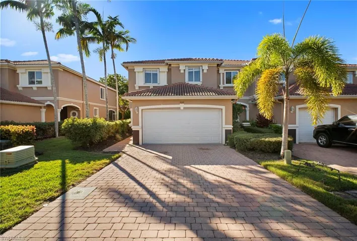 Mediterranean / spanish-style home featuring decorative driveway, stucco siding, and a tile roof