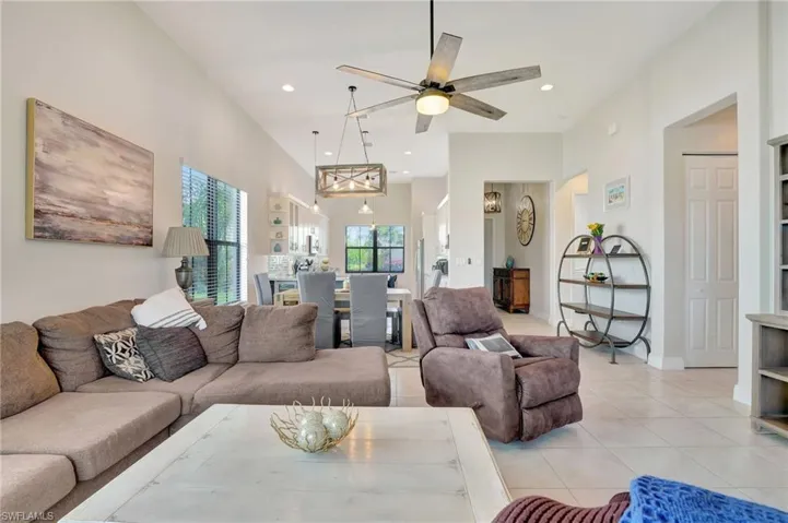Great room view overlooking kitchen, entry way, access to first bedroom