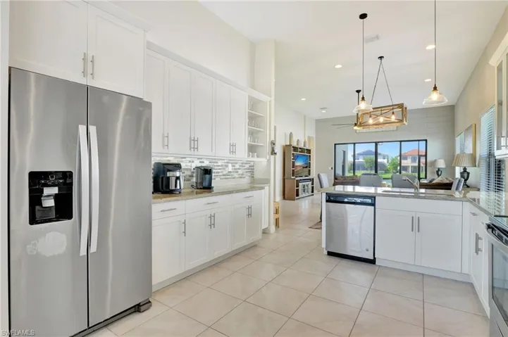 View from kitchen overlooking dining/great room area. lanai/lake.