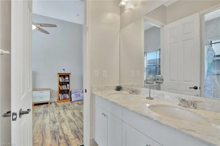 Dual vanity in jack/jill bath showing entrance into bedroom #3