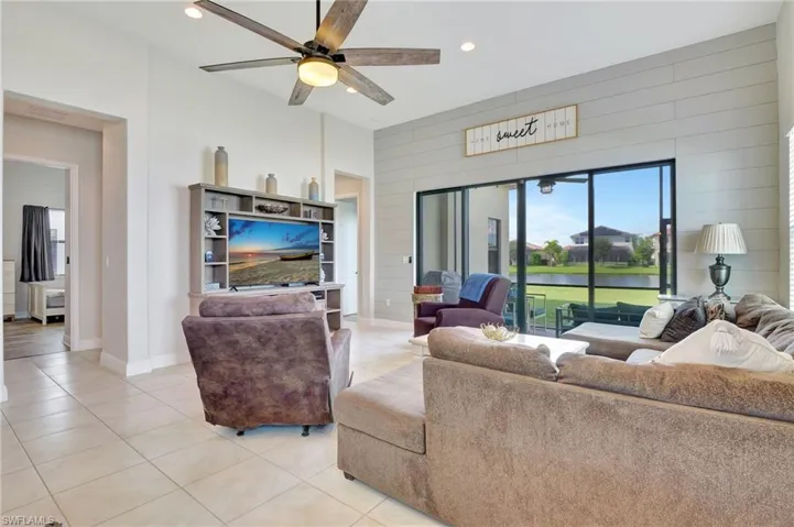 Living room featuring ceiling fan and light tile patterned floors