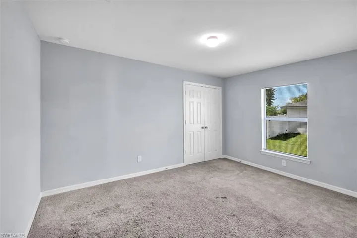 Unfurnished room featuring baseboards and carpet flooring