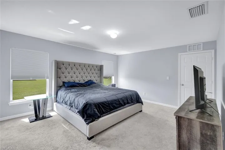 Bedroom with carpet and baseboards