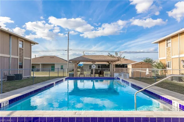 Community pool featuring a gazebo and a fenced backyard