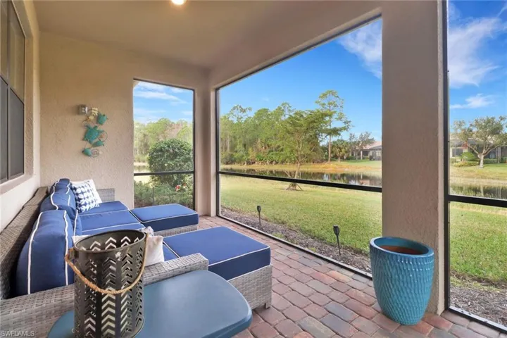 Sunroom featuring a water view