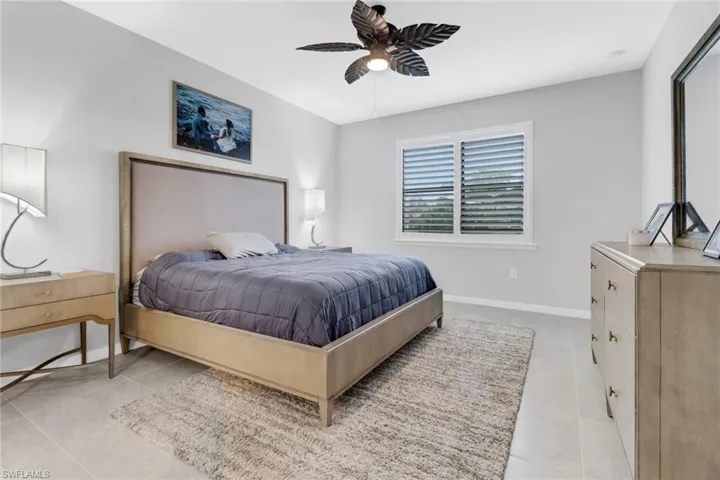 Tiled bedroom with ceiling fan