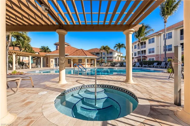 Community pool with a patio, a pergola, and a community hot tub
