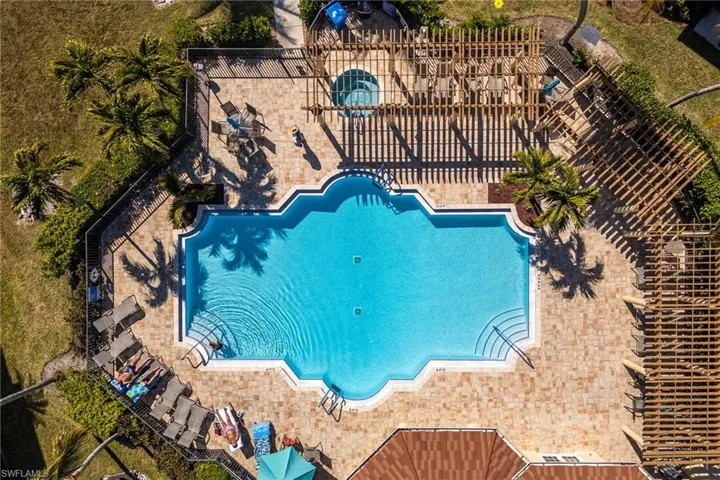 Community pool with a patio and a pergola
