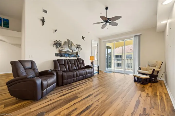 Living room featuring wood-type flooring and a ceiling fan