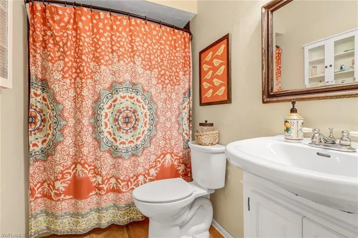 Guest bath with combo tub and shower.