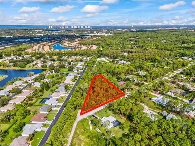 Aerial overview of property's location featuring property parcel outlined and nearby suburban area