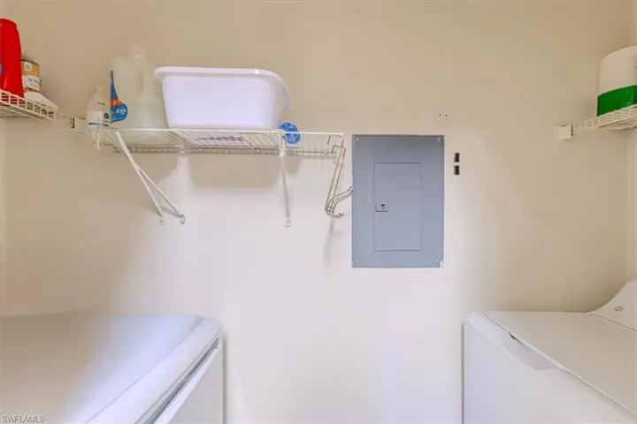 Washroom featuring electric panel and separate washer and dryer