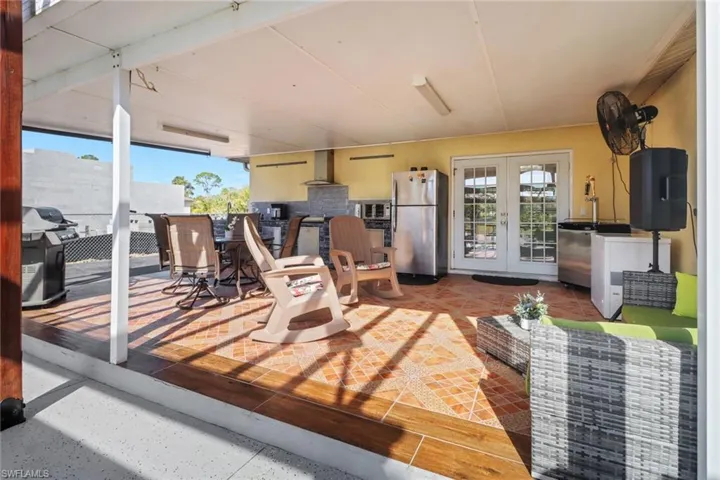 View of patio / terrace with washer / clothes dryer, outdoor dining area, and french doors