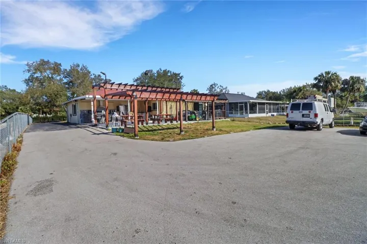 View of front of home with a pergola and fence