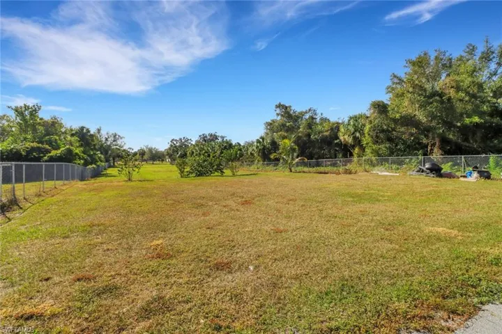 View of yard featuring fence