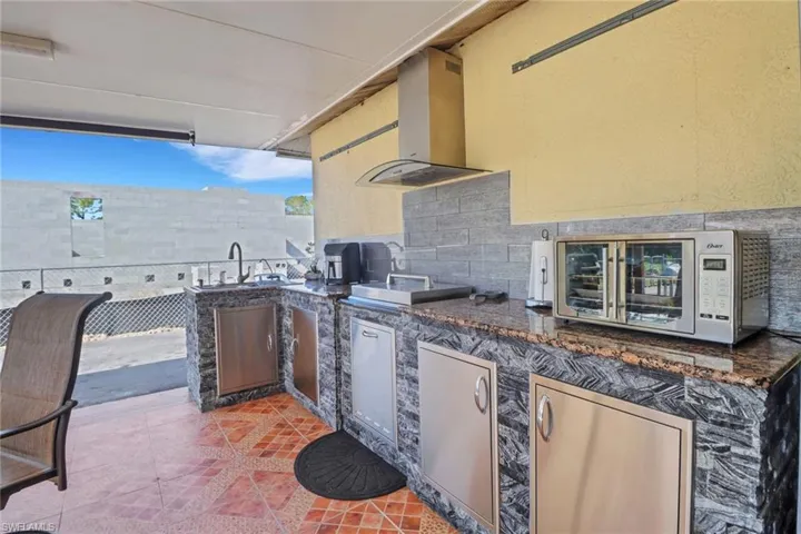 View of patio / terrace with exterior kitchen and a sink