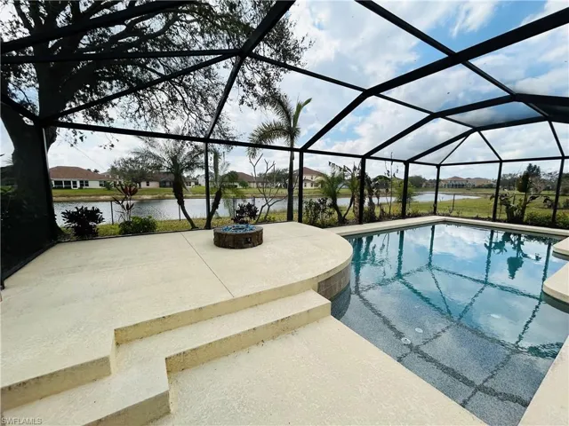 Swimming pool with a lanai, a residential view, a sunroom, and a patio