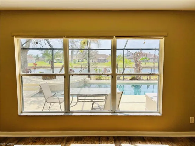 Detailed view of a residential view, wood finished floors, and nearby water