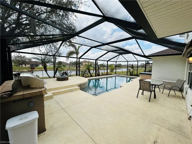 Outdoor pool with a sunroom, a patio area, a lanai, a residential view, and a water view