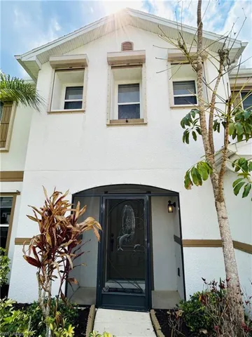 Entrance to property with stucco siding