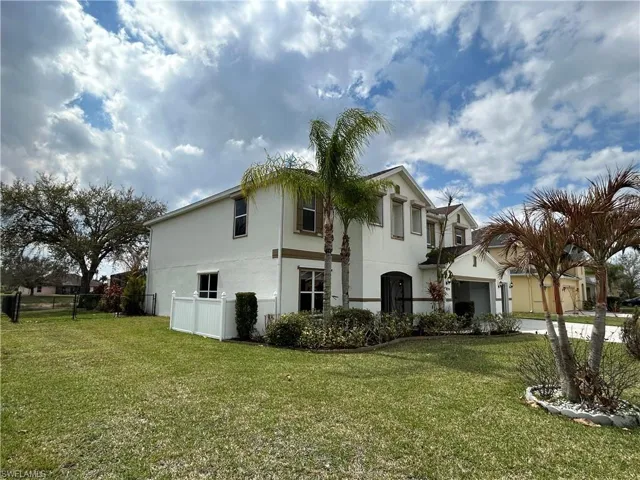 View of side of home featuring stucco siding and an attached garage