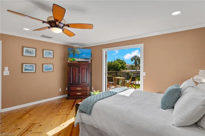 Bedroom with access to outside, light hardwood / wood-style flooring, ornamental molding, and ceiling fan