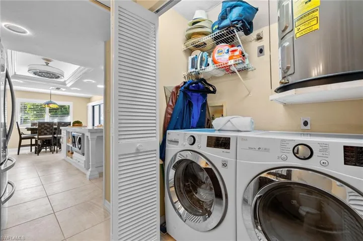 Laundry area featuring washer and clothes dryer and light tile patterned floors